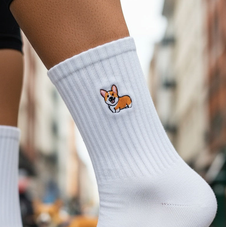 White sock with a dog illustration worn by a person on a blurred city street background