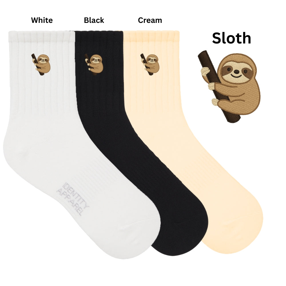 Three pairs of socks in white, black, and cream with sloth designs on a white background.