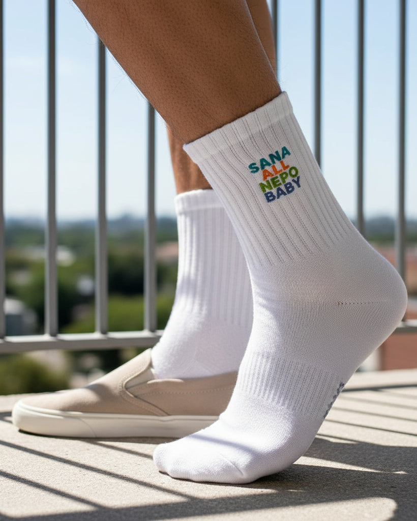 White socks with colorful text worn by a person on a balcony