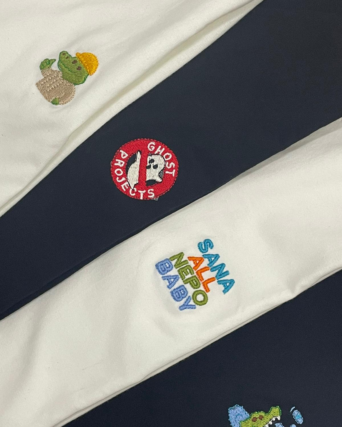 Navy and white fabric with embroidered logos and text