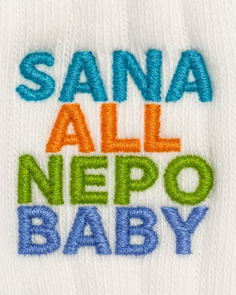 Embroidered text on a white background with colorful letters.