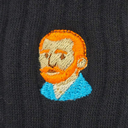 Embroidered patch of a man's face on a black background