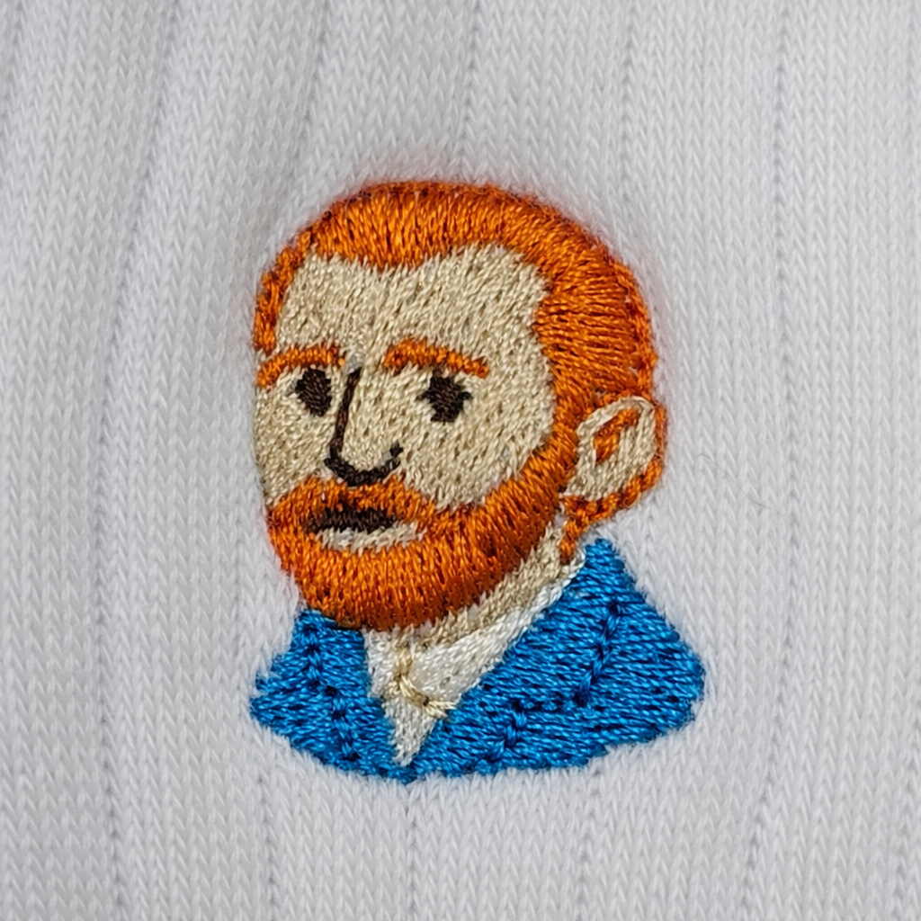 Embroidered patch of a man with red hair and a beard on a white fabric background